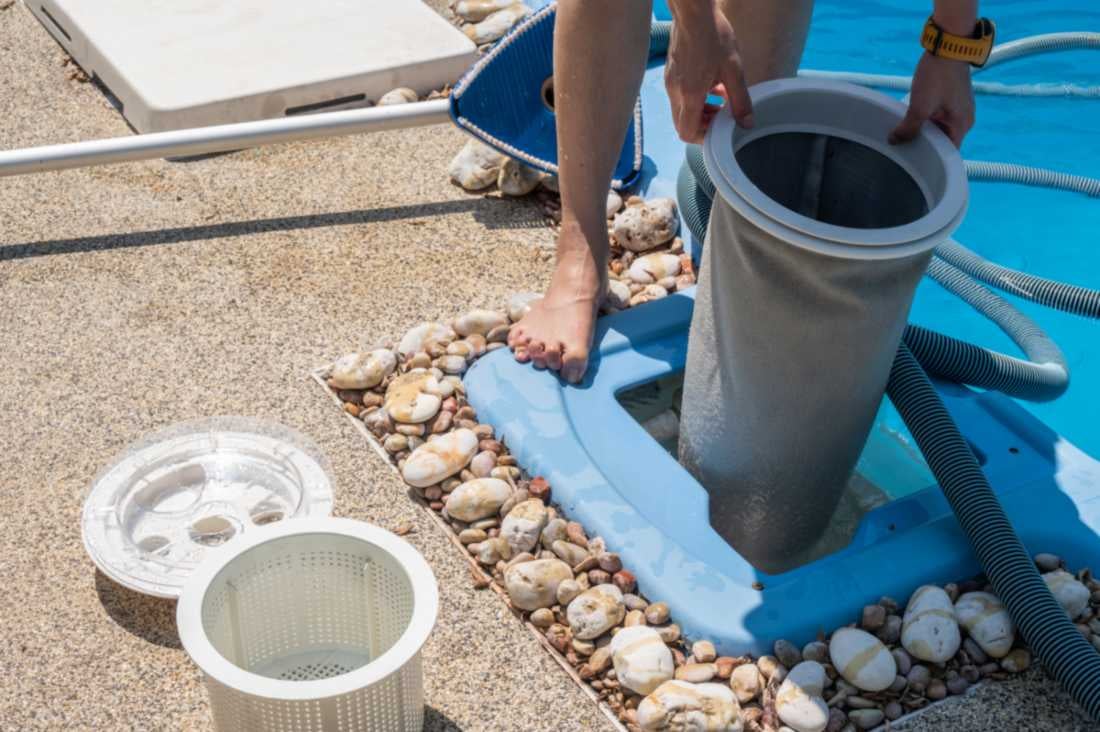 Technician trying to changing filter of pool skimmer